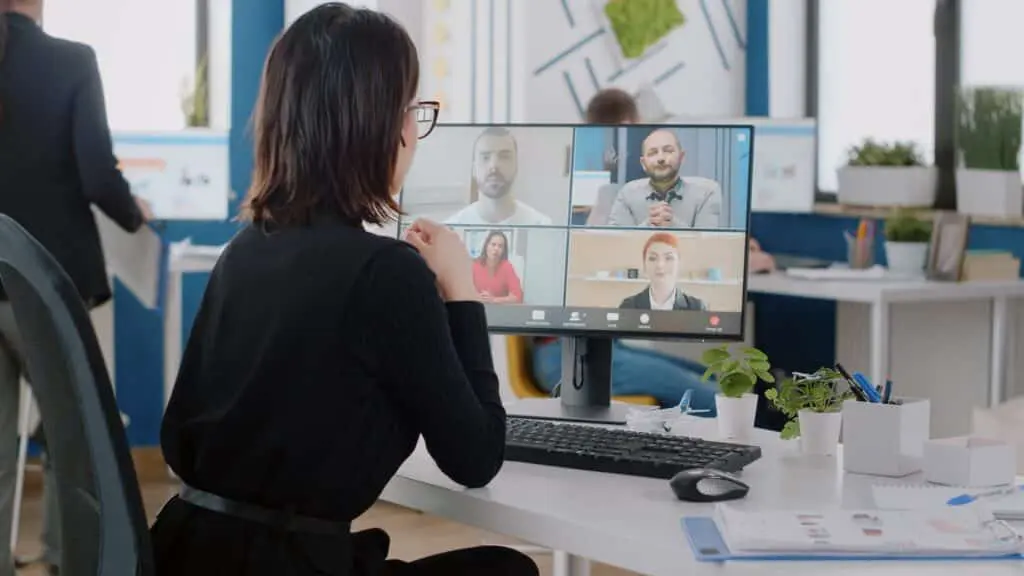 Corporate worker talking to colleagues on video call